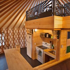 Interior photo of 24' yurt with several amenities.