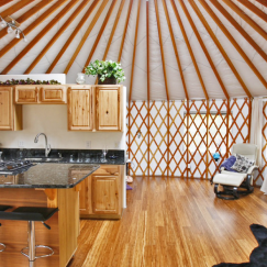 Small kitchen in a Pacific Yurt with an island with high-chair seating.
