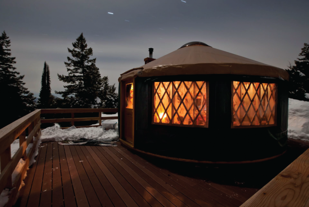 exterior of yurt in the snow in winter.